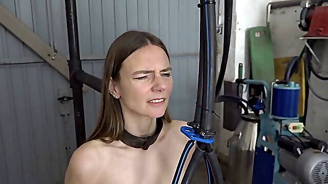 Slim brunette with small, saggy tits is sitting on a Sybian while her hands are tied up